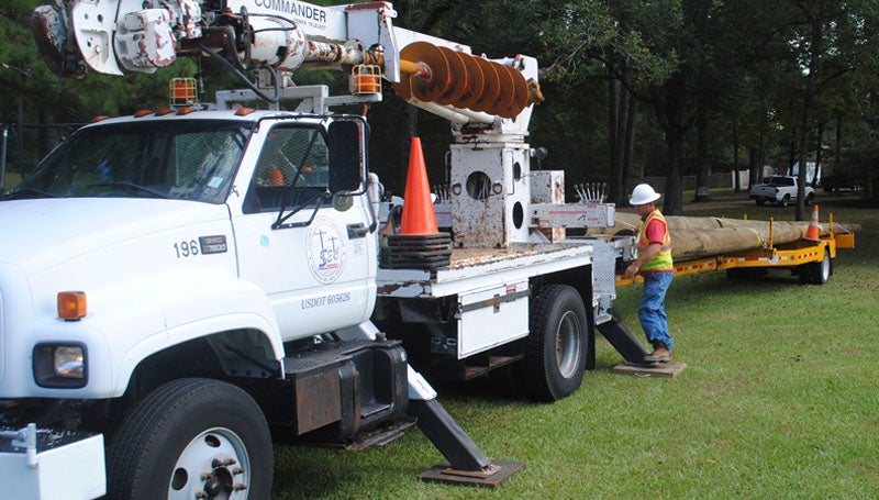 DAILY LEADER / JUSTIN VICORYInstallation of Brookhaven's long-awaited storm sirens is under way this week. On Monday, Jimmy Bell of Southern Electric Corp. prepares to unload a pole for an installation at Highway 51 and Denham Road. 