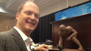 PHOTO SUBMITTED/ Dr. Kim Sessums is seen with the clay sculpture he was commissioned by the Mississippi Sports Hall of Fame to do in honor of Mississippi State and NFL great Kent Hull.
