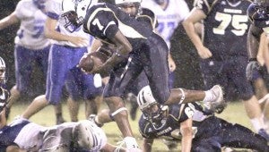 DAILY LEADER / JONATHON ALFORD / Bogue Chitto's Damien Terrell (7) scoops up a fumble against Sacred Heart and returns it for a touchdown Friday night at Troy Smith Field.