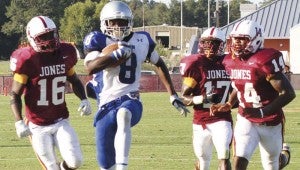DAILY LEADER / NATALIE DAVIS / Co-Lin's Casey Gladney (8) outruns Jones County's D'Andre Jackson (16), Charles Lewis (17) and Marcus Betts (14). Gladney had 10 catches for 168 yards and four touchdowns.