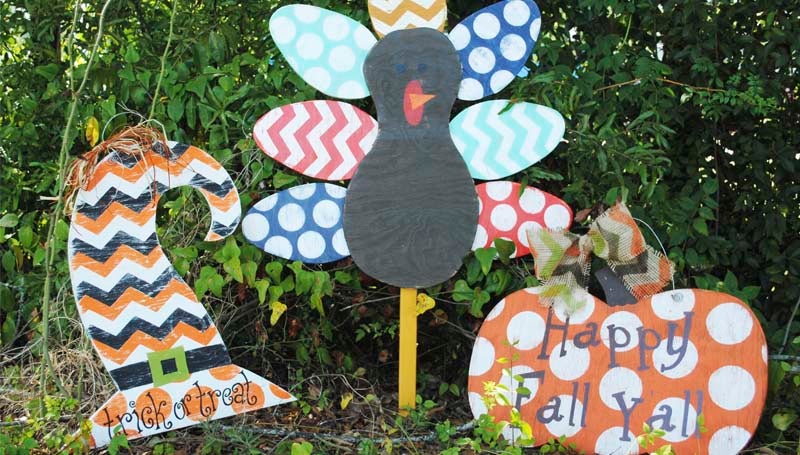 DAILY LEADER / JESSICA BOYD / Local business Two Sisters and Brush make many wooden decorations, including fun door hangers and colorful yard art for fall.