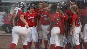 DAILY LEADER / MARTY ALBRIGHT / Sophomore slugger Katherine Shell (left) is greeted at home plate by her teammate after hitting a two-run home run in the bottom of the first inning Monday night at the Ole Brook Softball Complex.