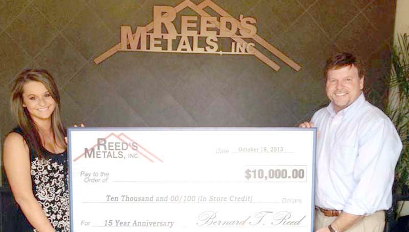 PHOTO SUBMITTED / Bernie Reed (right), owner and CEO of Reed's Metals, and employee Laina Watts showcase the grand prize of $10,000 in-store credit to be given away on Friday, Oct. 18, in honor of Reed's Metals 15th anniversary.