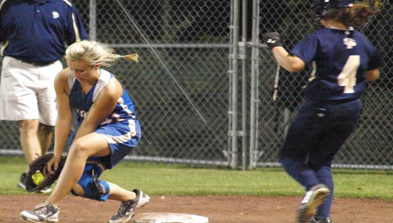 DAILY LEADER / TRACY FISCHER / Wesson first baseman Harmoni Ashley (left) gets out at first base as St. Patrick runner Sarah D'Azvilla (4) hustles to beat the play Tuesday night.