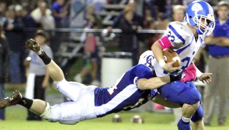 DAILY LEADER / SHERYLYN EVANS / Brookhaven Academy senior running back Landon Nettles (33) carries the ball and Copiah Academy defender Thomas Roberson for extra yard Friday night.