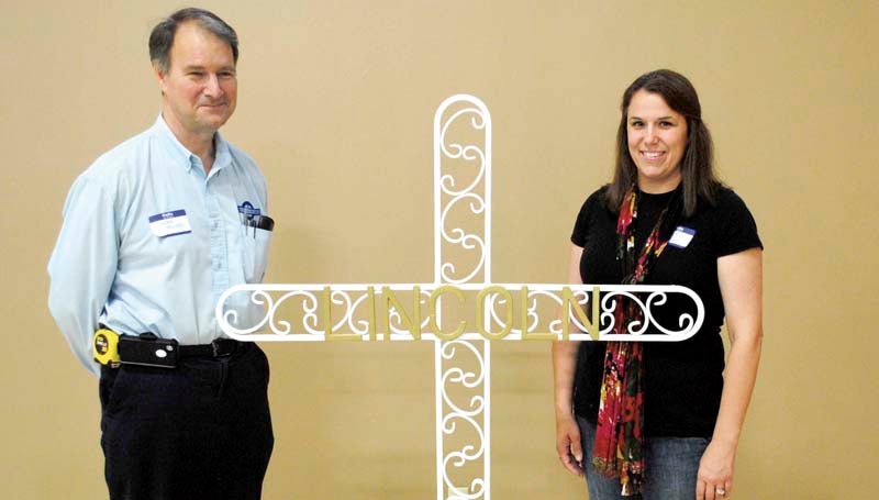DAILY LEADER / JUSTIN VICORY / Displaying the Brookhaven Mission Mississippi group's cross this week are (from left) James Minter, cross designer and artist, and Laura Ann Walker, who will be playing a supervisory role at the statewide Mission Mississippi event coming up in Jackson Sunday, Oct. 27.