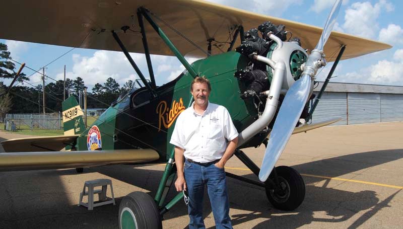 Ted Davis stands with his 1929 New Standard Biplane Monday.