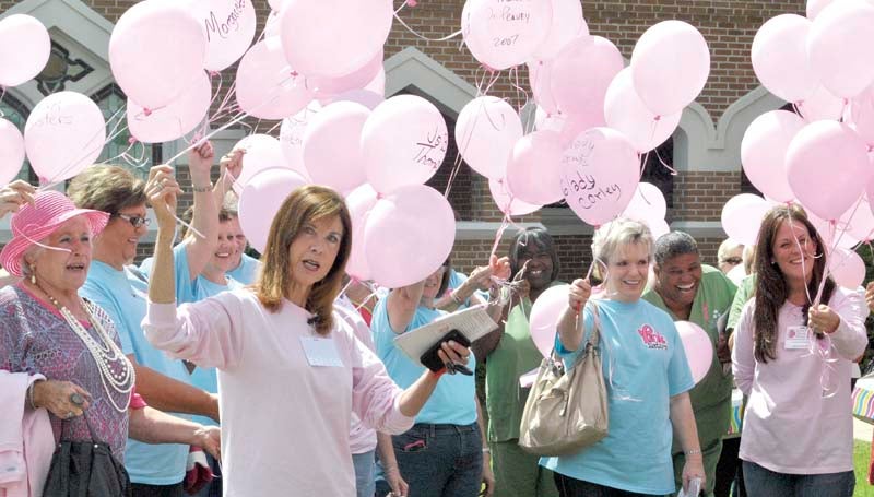 DAILY LEADER / RHONDA DUNAWAY / King's Daughters Medical Center Foundation board member and volunteer for Tuesday's Think Pink Breast Cancer Awareness luncheon, Kathy Walker, (front) honors breast cancer victims and survivors of the disease before balloons were released from the lawn of the Ole Towne Church.