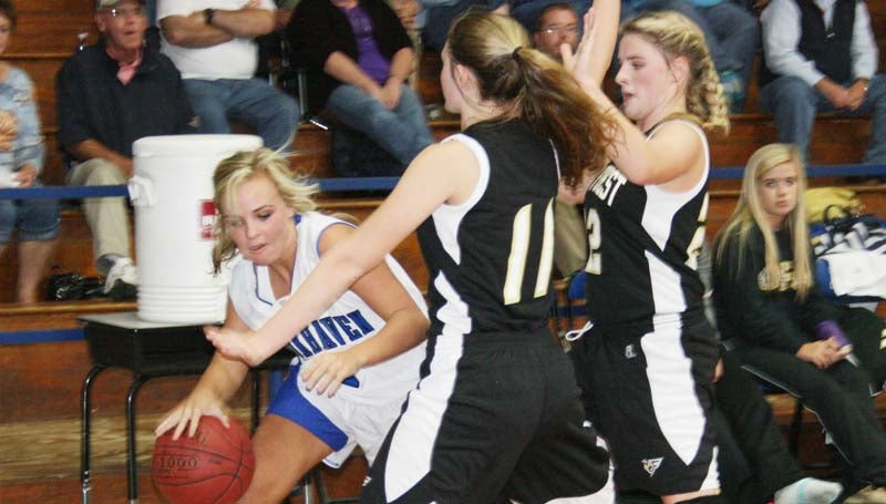 DAILY LEADER / MARTY ALBRIGHT / Brookhaven Academy's Hillary Wilson (4) tries to penetrate from the corner as Oak Forest defenders Payton Simmons (11) and Lindsey Neal (22) apply pressure Monday night.