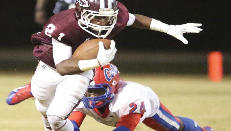 DAILY LEADER / BILLY W. FREEMAN Jr. / Hazlehurst's Dycelious Reese (21) sprints past a Forest defender for some positive yards Friday night at Robert McDaniel Sr. Stadium.