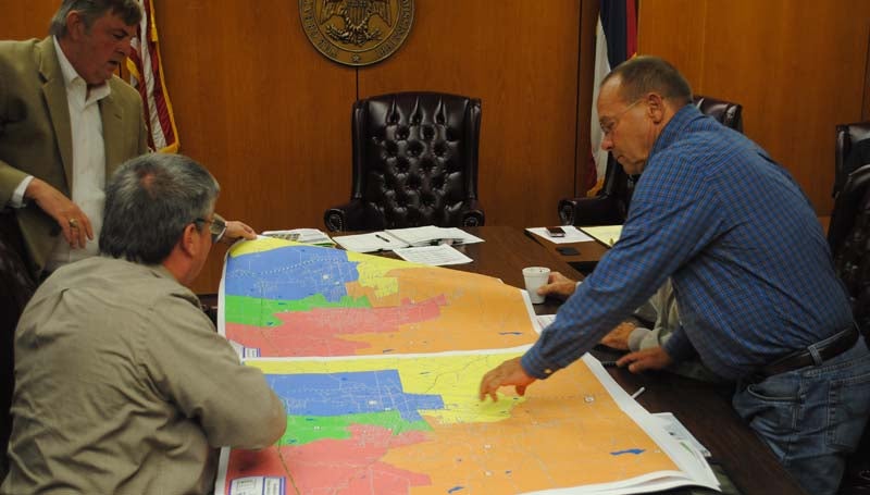 THE DAILY LEADER / JUSTIN VICORY / Redistricting consultant William Rigby (from left) consults with board of supervisors members Eddie Brown and Dudley Nations on potential changes to current district maps. 