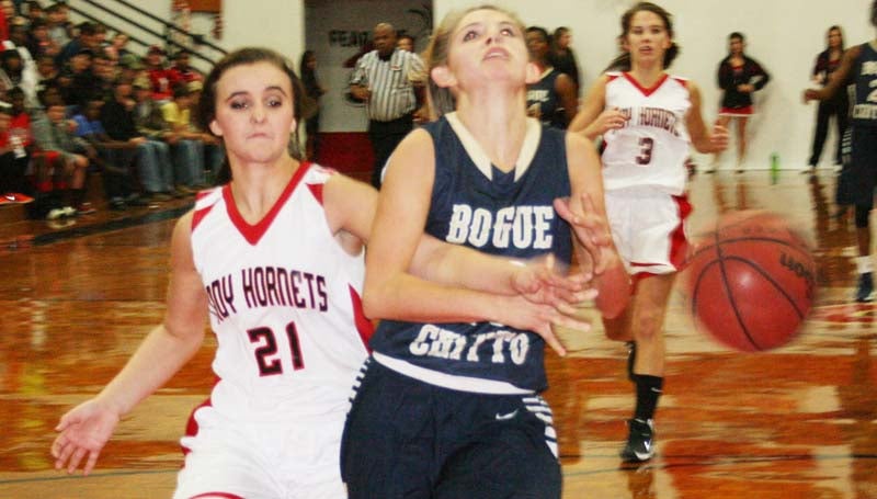 DAILY LEADER / MARTY ALBRIGHT / Bogue Chitto's Mattie Avants (10) drives in for a layup, but Loyd Star defender Marcie Givens (21) hustles in from behind to knock the ball away Tuesday night at Loyd Star gymnasium.