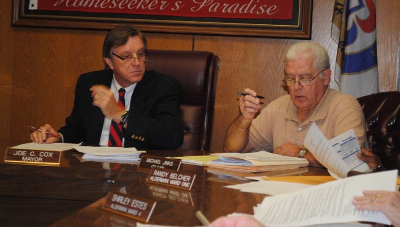 THE DAILY LEADER / JUSTIN VICORY / Mayor Joe Cox and City Clerk Mike Jinks contemplate the closure of a section of South Washington Street during discussion of the matter at Tuesday night's board of aldermen's meeting. 