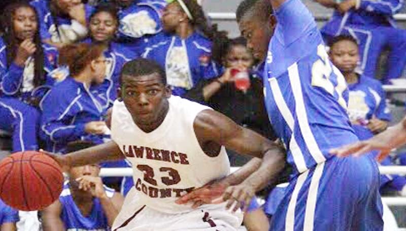 DAILY LEADER / JONATHON ALFORD / Lawrence County's sophomore Phillip Moore (23) penetrates the baseline against Tylertown's defender Aaron Jefferson (21) Friday night in Monticello.