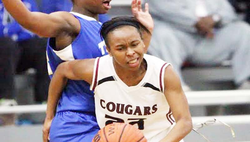 DAILY LEADER / JONATHON ALFORD / Lawrence County's junior guard Latasha Rhodes (23) receives a hard foul from Tylertown's Alisha Fortenberry (24) in girls' basketball action Friday night.