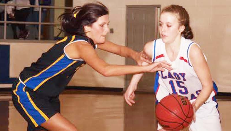 DAILY LEADER / TRACY FISCHER / Wesson guard Kayla Britt (15) handles the pressure of Sumrall's Olyvia Boutwell (13) Friday night.