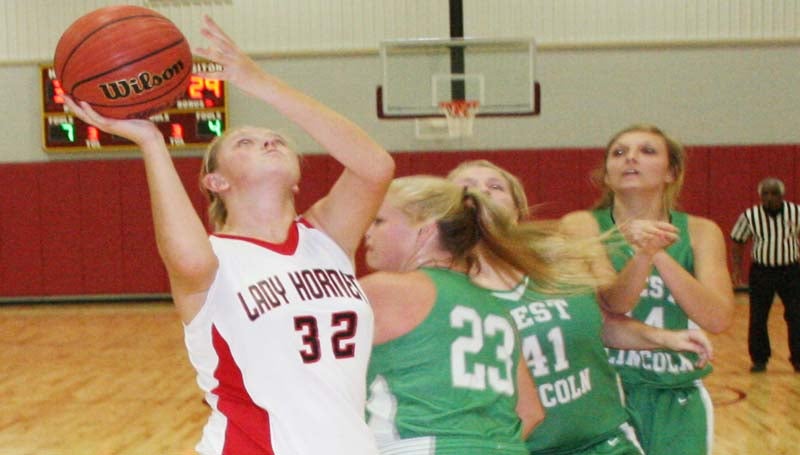 DAILY LEADER / MARTY ALBRIGHT / Loyd Star's Hannah Dickerson (32) scores an easy basketball as West Lincoln's defenders hustle in to deny the shot Thursday afternoon.