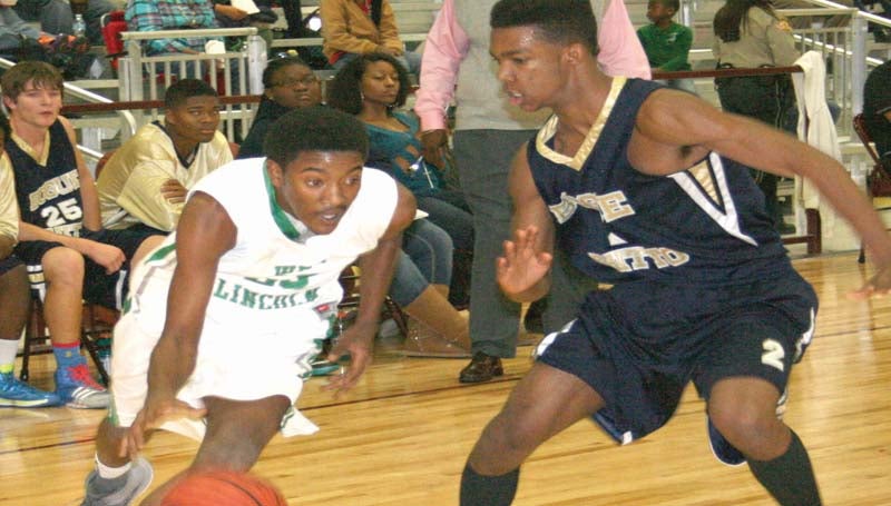 DAILY LEADER / MARTY ALBRIGHT / West Lincoln's Duane Marshall (left) drives past Bogue Chitto's Jeremiah Perkins in Friday night basketball action.