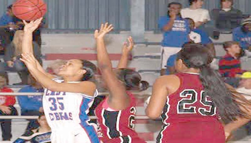 DAILY LEADER / TRACY FISCHER / Wesson's LaCatherine Hence (35) glides through the line to put the Lady Cobras ahead as Germantown's Lenesha Allen (21) tries to deny the shot Saturday night at the Snake Pit.