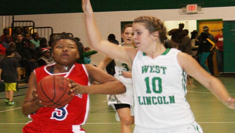 DAILY LEADER / MARTY ALBRIGHT / Brookhaven's Fredricka Fairman (3) drives in for a layup Friday night as West Lincoln defender Layton Sills (10) hustles to deny the play.