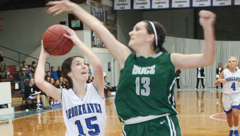 DAILY LEADER / MARTY ALBRIGHT / Brookhaven Academy's Mary Claire White (15) scores an easy basket for the Lady Cougars as Bowling Green's Reagan Moody leaps in to block the shot Monday night at John R. Gray Gymnasium.