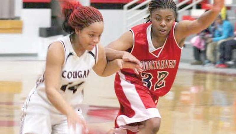 DAILY LEADER / SUBMITTED / Brookhaven's Diamond Herring (32) applies defensive pressure on Lawrence County's Nikedra Brown (14) Friday night in basketball action.