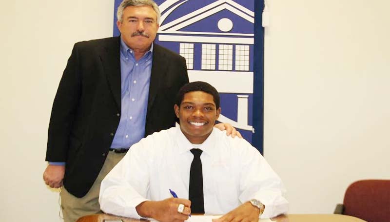 CO-LIN MEDIA / NATALIE DAVIS / ADAMS SIGNS WITH ULL - Copiah-Lincoln Community College offensive lineman David Adams of Rolling Fork has signed with the University of Louisiana-Lafayette Rajun Cajuns. Adams (6-4, 275) missed nearly his entire freshman season after suffering a serious leg injury. He was named Mississippi Association of Community/Junior College (MACJC) Second Team All-State. In his two years at Co-Lin, the Wolfpack posted a 16-5 record, winning the MACJC State Championship in 2012. Pictured with Adams is Co-Lin head coach Glenn Davis.