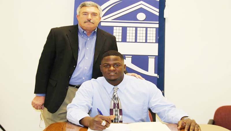 CO-LIN MEDIA / NATALIE DAVIS / JARRETT SIGNS WITH SLU - Copiah-Lincoln Community College defensive lineman Philanteus Jarrett of Hollendale has signed with the Southeastern Louisiana University Lions. Jarrett (6-3, 280) accounted for 22 tackles and one quarterback sack and was selected to play in the MACJC All-Star Game. He joins former Wolves Darius Guy, Devante Scott, Marquis Hayes, and A.J. Bowen. In his two years at Co-Lin, the Wolfpack posted a 16-5 record, winning the MACJC State Championship in 2012. Pictured with Jarrett is Co-Lin head coach Glenn Davis.