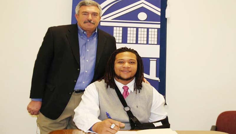 CO-LIN MEDIA / NATALIE DAVIS / JOHNSON SIGNS WITH MSU - Copiah-Lincoln Community College defensive lineman Jocquell Johnson of Jackson has signed with Mississippi State University. Johnson (6-5, 305) is the first Co-Lin player to sign with Mississippi State since 2007. In his two years at Co-Lin, the Wolfpack posted a 16-5 record, winning the MACJC State Championship in 2012. Pictured with Johnson is Co-Lin head coach Glenn Davis.