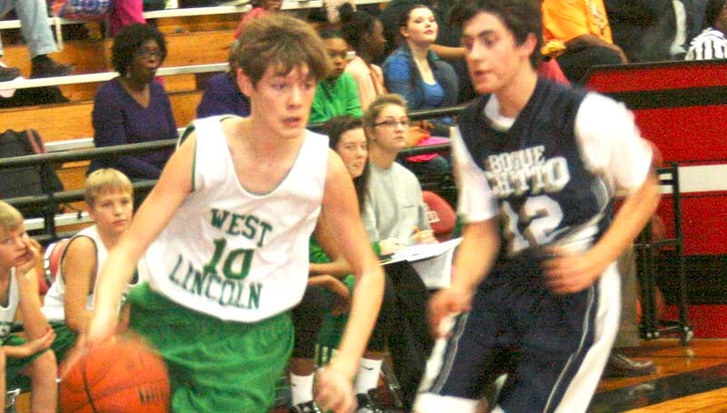 DAILY LEADER / MARTY ALBRIGHT / West Lincoln's Adam Mastinet (10) drives past Bogue Chitto's defender Tucker Lambert (12) Thursday night in junior high tournament action at Loyd Star.