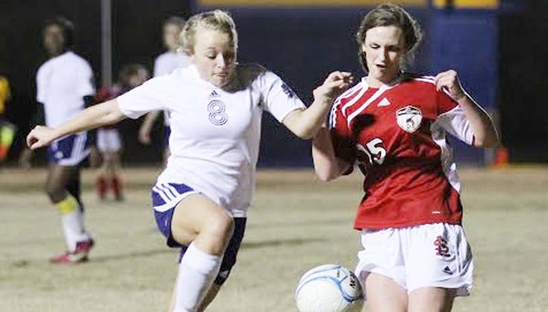 DAILY LEADER / AMY RHOADS / Loyd Star's Megyn Rhoads (15) battles for the ball against Franklin County's Kristlyn Kent (8) Thursday night in girls soccer action. The undefeated Lady Bulldogs blanked the Lady Hornets 5-0.