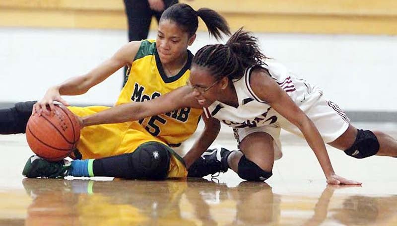 DAILY LEADER / JONATHON ALFORD / Lawrence County's Latasha Rhodes and McComb's Chardonay Williams (15) battle for the loose ball Friday night in Monticello.
