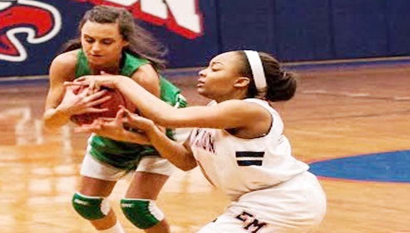 DAILY LEADER / TERESA ALLRED / West Lincoln guard Karley "Squishy" Smith fights for the loose ball against an East Marion defender Friday night in Columbia.
