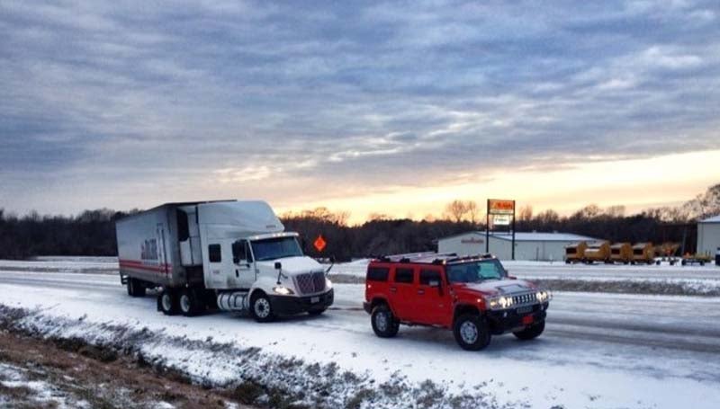 PHOTO SUBMITTED / Becky Skelton's Hummer helps out with a tow for a McLane truck that jackknifed on Highway 84  in the ice and snow.