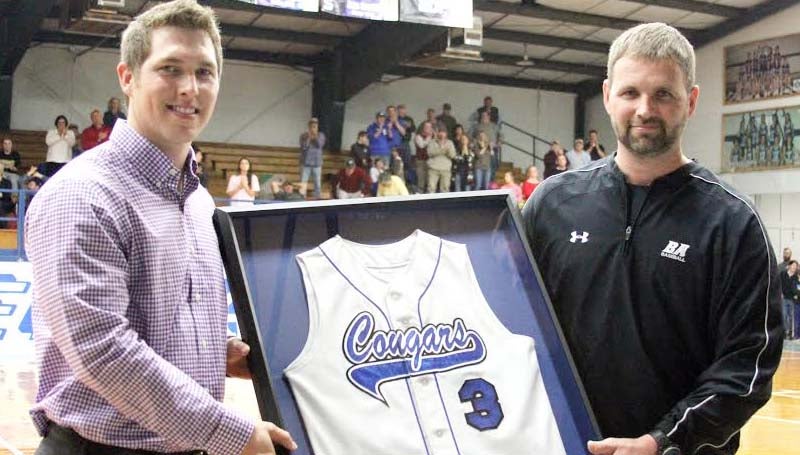 DAILY LEADER / SHERYLYN EVANS / Corey Dickerson (left) proudly holds his retired high school jersey along with BA head baseball Coach Casey Edwards during a special ceremony Friday night at John R. Gray Gymnasium.