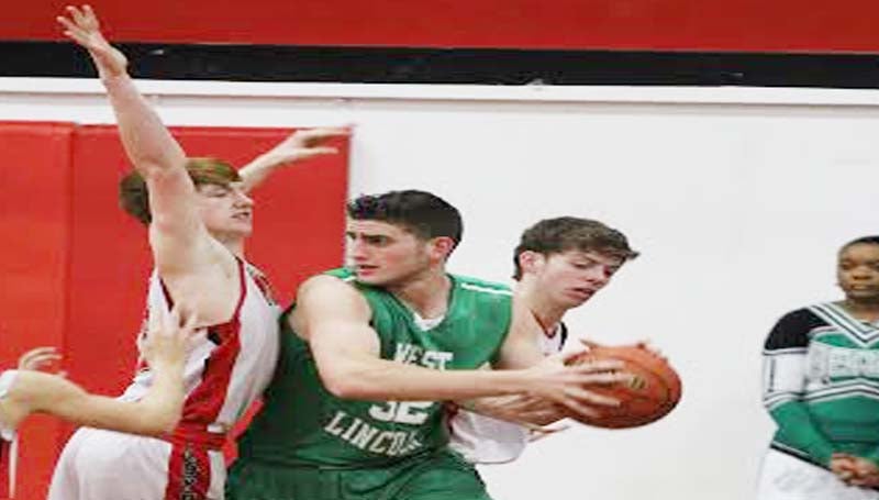 DAILY LEADER / AMY RHOADS / Loyd Star's  Levi Redd (23) and Brad Jasper (14) team up to apply defensive pressure on West Lincoln's Sam Bivens (32) Friday night.