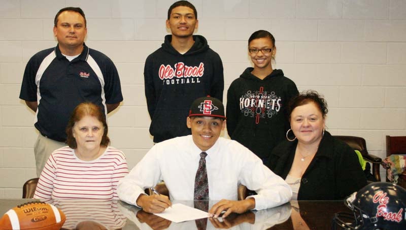 DAILY LEADER / MARTY ALBRIGHT / TREVILLION SIGNS WITH SAN DIEGO STATE - Brookhaven quarterback Fred Trevillion (seated second from left) has signed with the San Diego State Aztecs. Pictured with Fred are (seated from left) his grandmother, Kathy Edwards; his mother, Stephanie Trevillion; (standing) Brookhaven head coach Tommy Clopton; Fred's brother Javontae Trevillion and sister Destiny Trevillion.