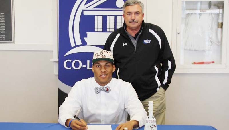 CO-LIN MEDIA / NATALIE DAVIS / HUTCHERSON SIGNS WITH MSU - Copiah-Lincoln Community College (Miss.) tight end Darrion Hutcherson (6-7, 245) of Dadeville, Ala., has signed with Mississippi State University. In his two years at Co-Lin, the Wolfpack posted a 16-5 record, winning the MACJC State Championship in 2012. Pictured with Hutcherson is Co-Lin head coach Glenn Davis.