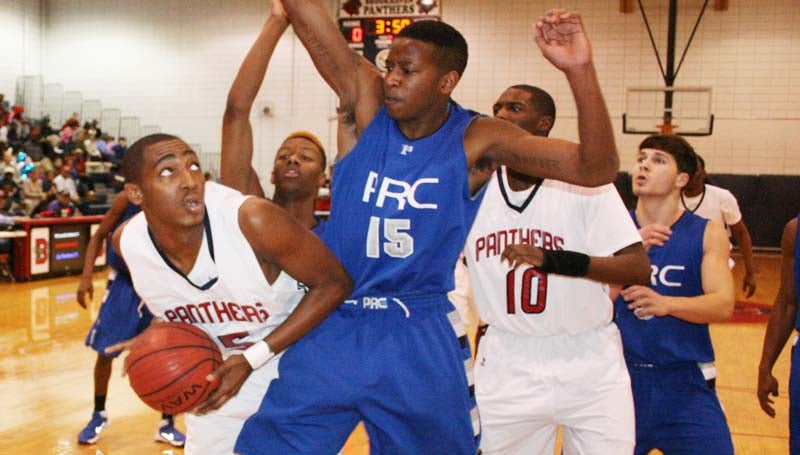 DAILY LEADER / MARTY ALBRIGHT / Brookhaven forward Tavis Moore powers to the basketball as Pearl River Central defender Terek Whitehead tries to deny the play Friday night in Sinclair Gymnasium.