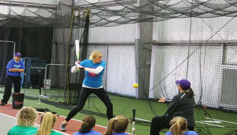 DAILY LEADER / MARTY ALBRIGHT / Olympics gold medalist Jennie Finch provides some helpful tips on batting techniques to several local coaches and girls in Saturday softball camp at KDMC Performance Center.