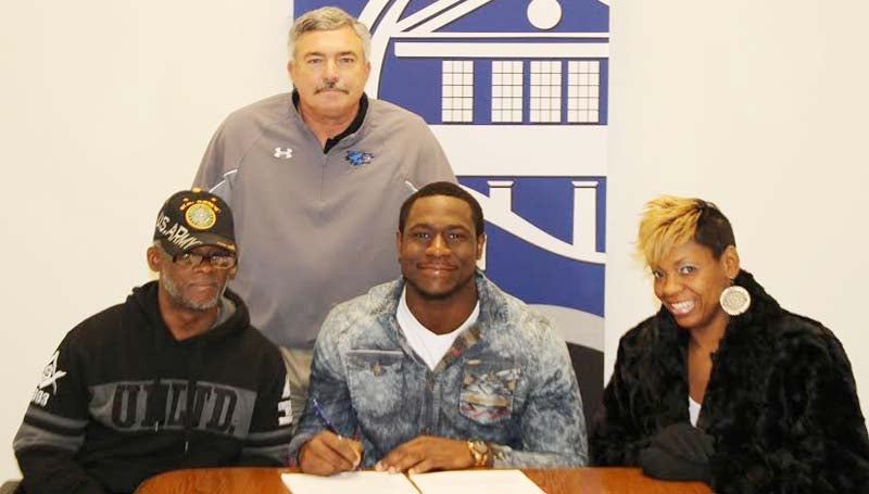 CO-LIN MEDIA / NATALIE DAVIS / PHILLIPS SIGNS WITH ILLINOIS - Copiah-Lincoln Community College (Miss.) defensive lineman Caroll Phillips of Miami, Fla., has signed with the University of Illinois. Pictured with Phillips is his uncle, Kevin Adderly of Nashville, Tenn.; his mother Ta-Tanisha Brown of Miami and Co-Lin head coach Glenn Davis (standing).