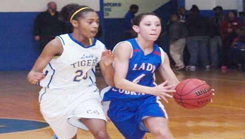 DAILY LEADER / TRACY FISCHER / Wesson Brandi McInnis (4) tries to drive by Crystal Springs' ShaQuan Byther (23) Tuesday night in region basketball action.