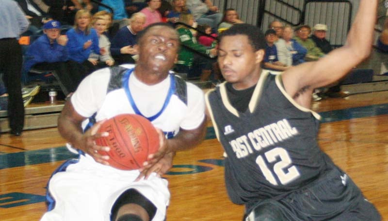 DAILY LEADER / MARTY ALBRIGHT / Co-Lin's Michael Vardaman (left) drives past East Central's Ramone Tate (12) Thursday night in men's action.