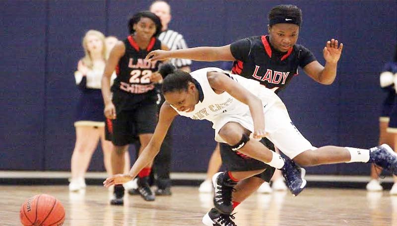 DAILY LEADER / JONATHON ALFORD / Bogue Chitto's Zariah Mathews (2) receives a hard foul from Pelahatchie's Jamiyah Stokes (24) while chasing down a loose ball Friday night in girls' Region 7-1A tournament action.