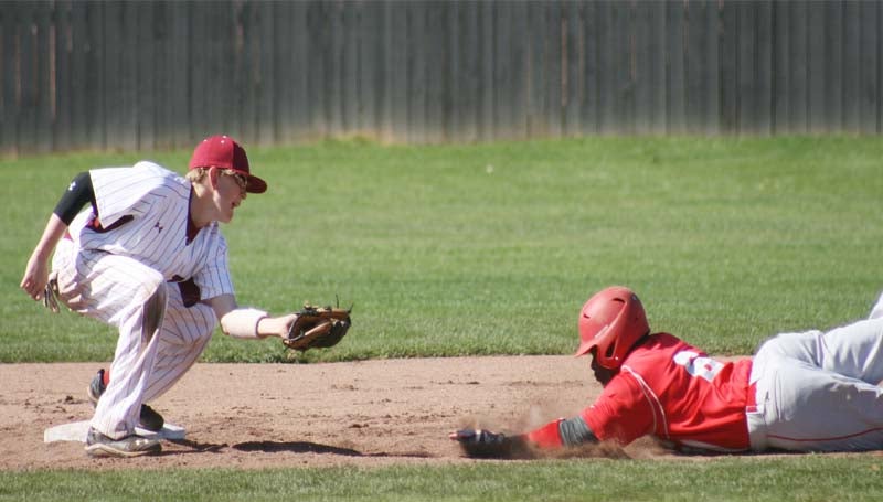 DAILY LEADER / MARTY ALBRIGHT / Lawrence County second baseman Kasey Durr (left) squares up to make the tag on Magee's runner Alonzo Brown (6) sliding in for the out Wednesday afternoon in Southwest Mississippi Spring Break Baseball Classic.