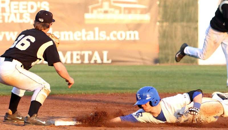 DAILY LEADER / SHERYLYN EVANS / Co-Lin's Ryan Young (14) slides safely into second base after his line drive double to right field, as East Central shortstop Ryan Ward (16) waits on the throw in the second game.