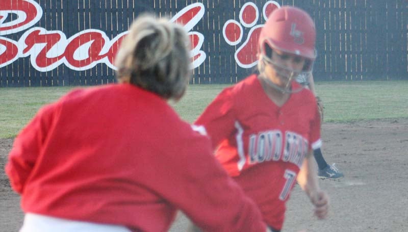 DAILY LEADER / MARTY ALBRIGHT / Loyd Star Lexie Butler receives congratulations from her coach Jan Delaughter while rounding third base Tuesday against Brookhaven. Butler smashed a two-run and three-run homer to power the Lady Hornets.