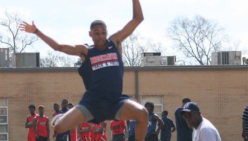 DAILY LEADER / MARTY ALBRIGHT / Brookhaven's Marte Jones soars through the air on his long jump attempt Saturday.
