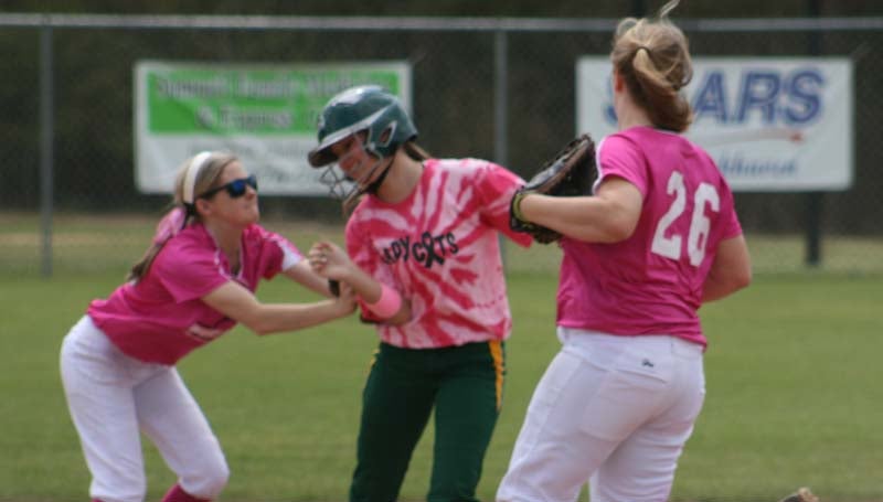 DAILY LEADER / MARTY ALBRIGHT / West Lincoln's Peyton White (left) tags out Salem's pinch runner Audrey Stogner in a rundown as Bentley Sills (26) looks in on the action Saturday.