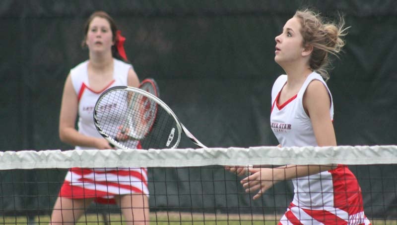 DAILY LEADER / MARTY ALBRIGHT / Loyd Star's Lani Smith (left) and Faith Bergeron wait on the serve from West Lincoln in No. 2 girls double tennis action Friday at the City Courts.